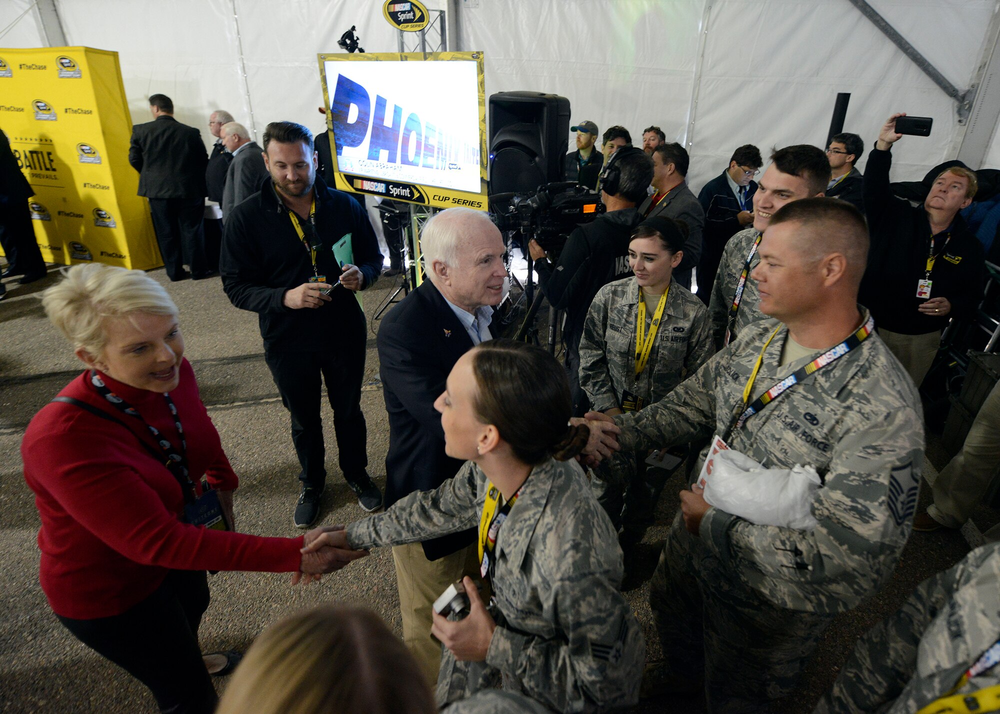 U.S. Senator John McCain, center, greets Luke Airmen during the NASCAR's drivers meetingat the Phoenix International Raceway, Ariz., Nov. 15, 2015. Veterans, active military members and their families were front and center for the race as NASCAR honor their service and sacrifice for the nation. (U.S. Air Force photo by Senior Airman Devante Williams)