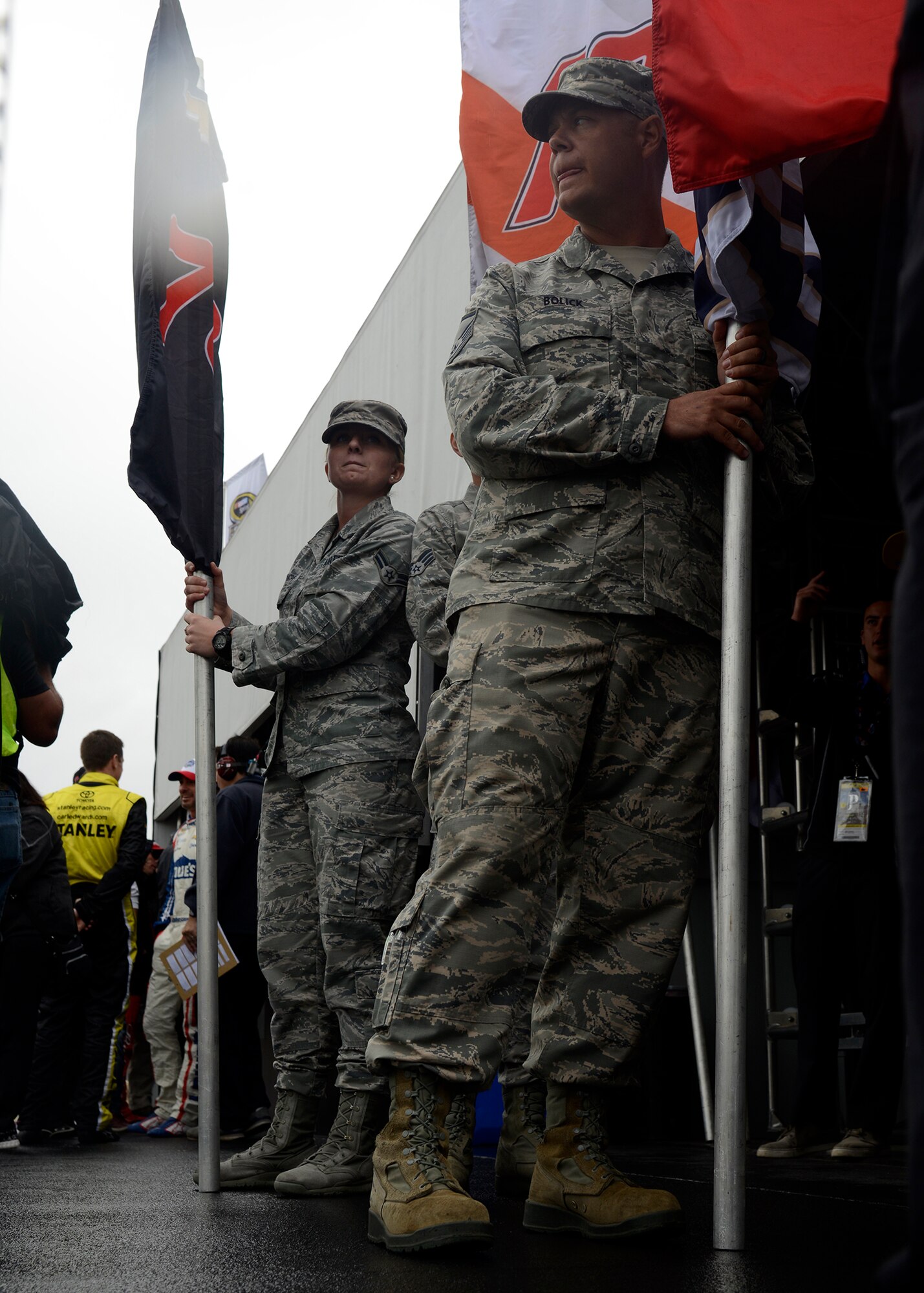 Master Sgt. Timothy Bolick, 61st Aircraft Maintenance Unit F-35 specialist training monitor, and Airman First Class Katliyn Straight, 56th Medical Operations Squadron medical technician, holds the driver’s flag during the opening ceremony of the Quicken Loans Race for Heroes 500 at the Phoenix International Raceway, Ariz., Nov. 15, 2015. For the eight racers racing for the final four slots of “The Chase,” an Airman was chosen to hold that driver's flag. (U.S. Air Force photo by Senior Airman Devante Williams) 