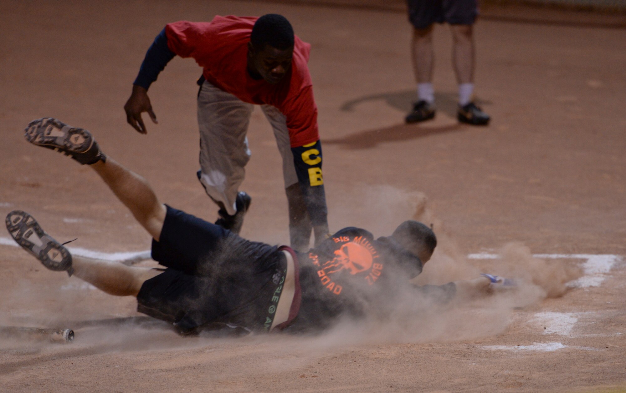 Airman 1st Class Levi Paulaydt, 61st Aircraft Maintenance Unit player, dives into home plate to score a clutch run just before being tagged by a defender at Luke, Nov. 17, 2015. The 61st AMU scored nine runs in the last full inning of the game. (U.S. Air Force photo by Airman 1st Class Ridge Shan)