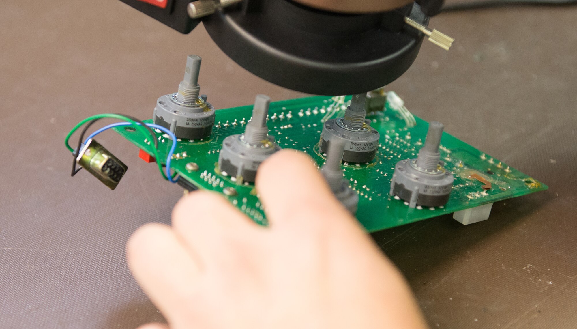 U.S. Air Force Senior Airman Tyler Jenkins, an Air Force Repair Enhancement Program technician with the 354th Maintenance Squadron, inspects a speed panel Nov. 16, 2015, at Eielson Air Force Base, Alaska. Jenkins inspected the panel for the 354th Security Forces Squadron to ensure the soldering joints are serviceable. (U.S. Air Force photo by Airman 1st Class Cassandra Whitman/Released)