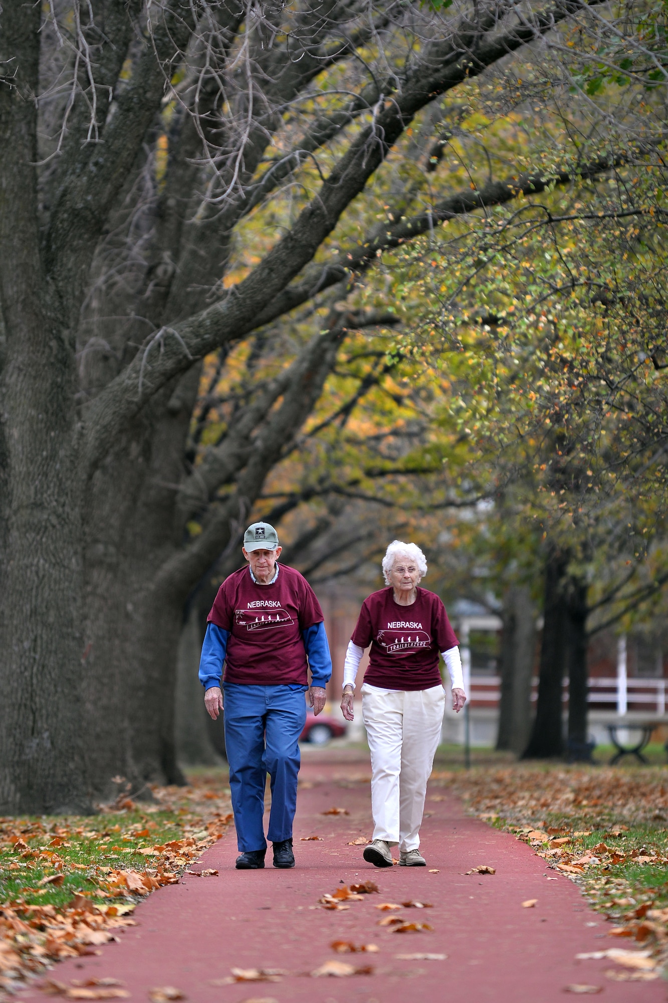 Jim and Sheila Goeltz walk along the running track on Nov. 6, on the Parade Grounds of Offutt Air Force Base, Neb.  Jim and Sheila have been staples of the Offutt community with a combined 52 years of volunteering between the two.  Jim has been a part of the Retiree Activities Office and Sheila a volunteer at the Offutt Thrift Shop.  (U.S. Air Force photo by Josh Plueger/Released)