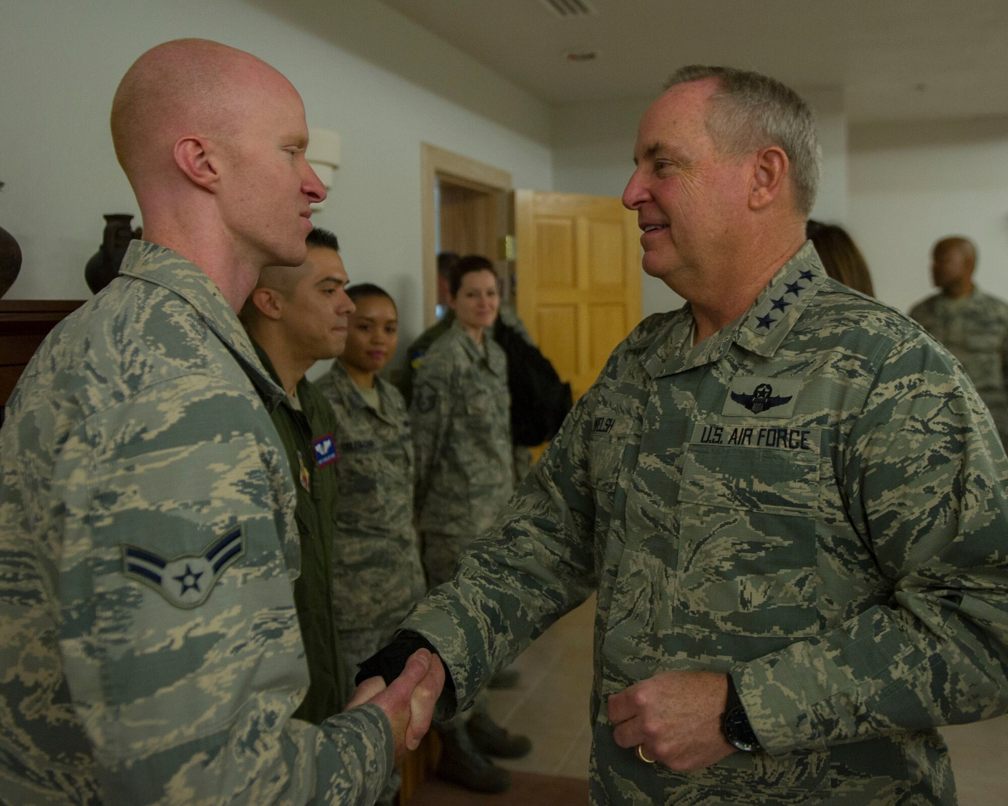Airman 1st Class James Jones, a 49th Civil Engineer Squadron explosive ordnance disposal technician, receives a coin from Gen. Mark A. Welsh III, the Air Force Chief of Staff, during Welsh’s visit to Holloman Air Force Base on Nov. 17. Jones was one of five Airmen who were recognized for superior performance. (U.S. Air Force photo by Senior Airman Emily A. Kenney) 