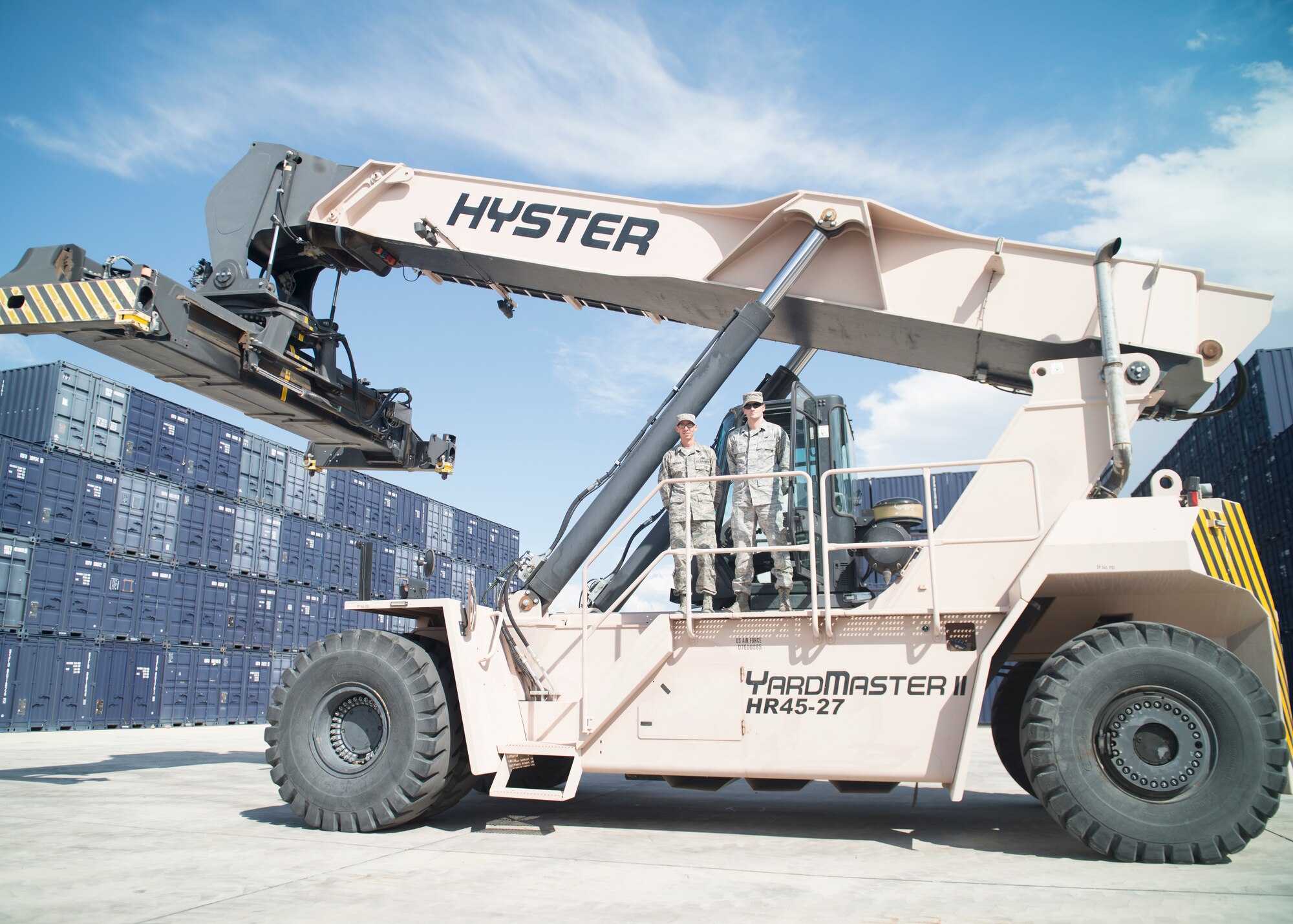 Staff Sgt. Gilberto Padilla and Senior Airman Christopher Williams, 49th Materiel Maintenance Group vehicle operators, stand in front of one of only three operational Hyster 100k Reach Stackers within the Continental United States Air Force at Holloman Air Force Base N.M. Padilla and Williams are proud to be serving the Air Force with their contribution to the BEAR Base mission. They both have their reasons for serving, each revolving around protecting the United States and their families. The work they do directly allows the quick set up of temporary bases down range in support of national security operations as well as humanitarian support efforts. 
