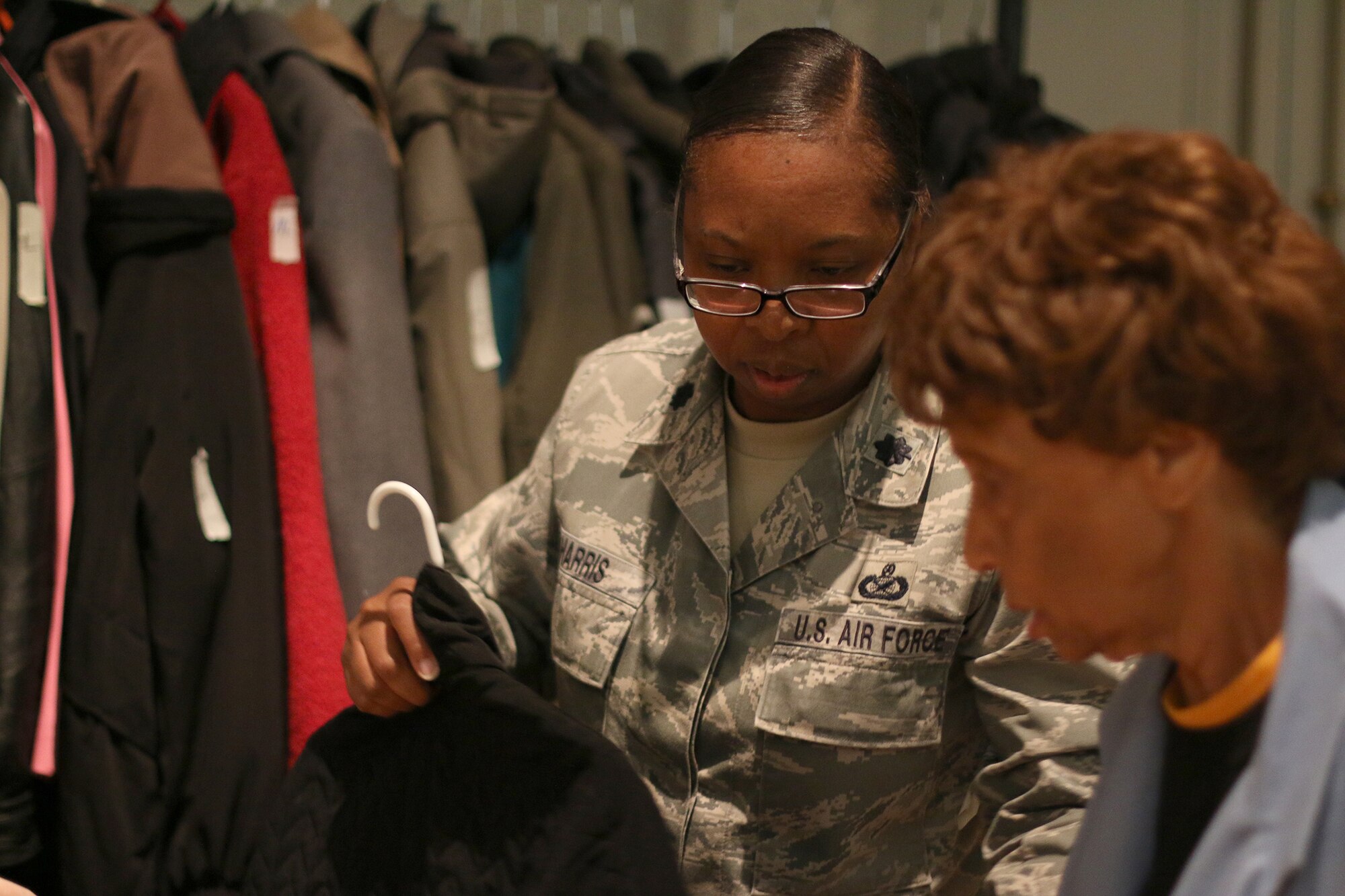 DAYTON, Ohio – Lt. Col. Cynthia Harris, 445th Public Affairs chief, assists a veteran member of the Dayton Veterans Affair’s Medical Center Homeless Stand down October 29, 2015.  More than 10 members of the 445th Airlift Wing volunteered for the event. This year’s homeless stand down provided  a meal, clothing, health screenings, VA and Social Security benefits counseling, and referrals to a variety of other necessary services, such as: housing, employment, substance abuse and mental health treatment services to more than 300 veterans. The purpose of the event is to raise awareness for the difficulty in which Veterans and their families endure. (U.S. Air Force photo /Tech. Sgt. Patrick O’Reilly)
