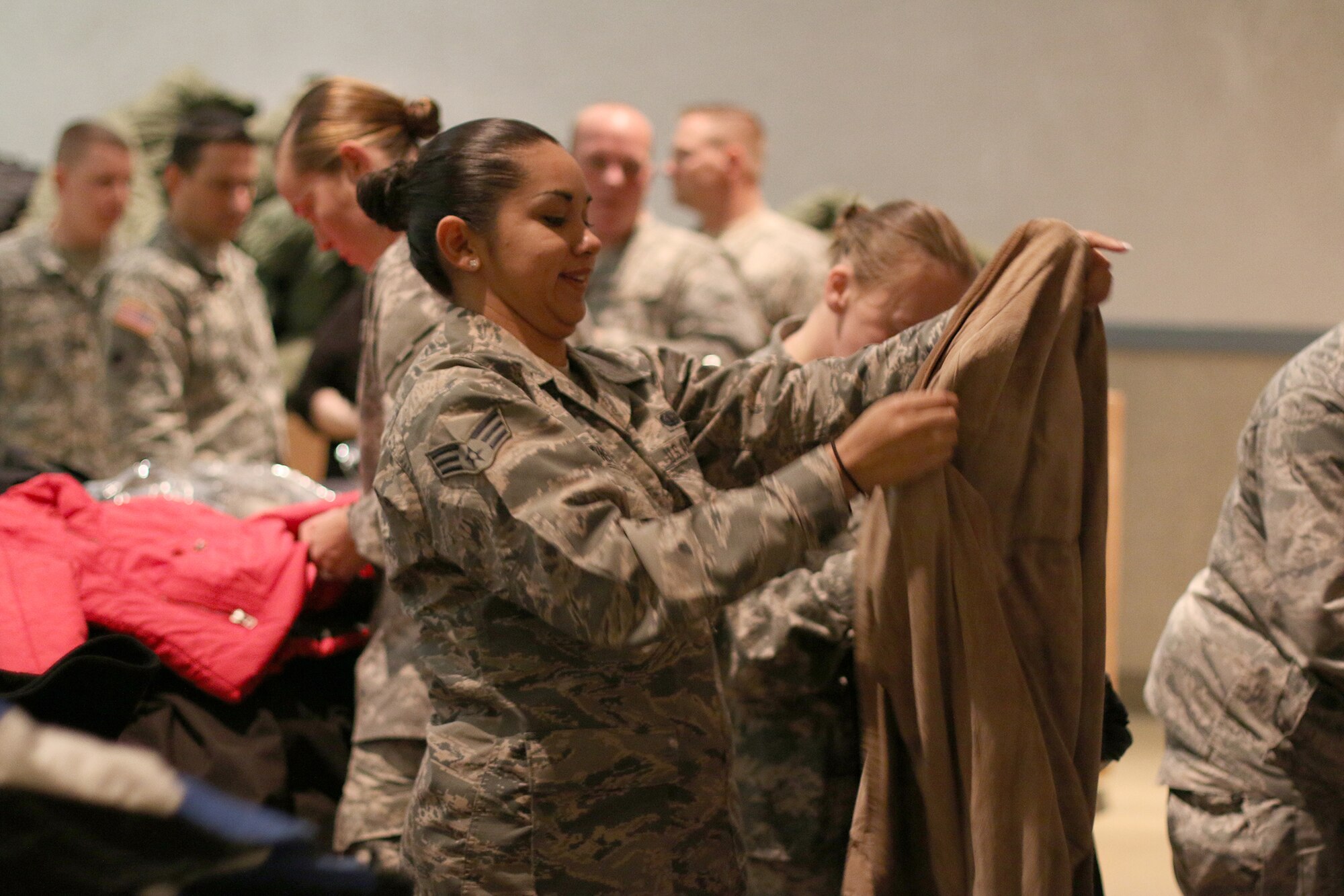 DAYTON, Ohio – Senior Airman Stephanie Gardner, 445th Force Support Squadron, sorts coats to be distributed during the Dayton Veterans Affair’s Medical Center Homeless Stand down October 29, 2015.  More than 10 members of the 445th Airlift Wing volunteered for the event. This year’s homeless stand down provided  a meal, clothing, health screenings, VA and Social Security benefits counseling, and referrals to a variety of other necessary services, such as: housing, employment, substance abuse and mental health treatment services to more than 300 veterans. The purpose of the event is to raise awareness for the difficulty in which Veterans and their families endure.  (U.S. Air Force photo /Tech. Sgt. Patrick O’Reilly)