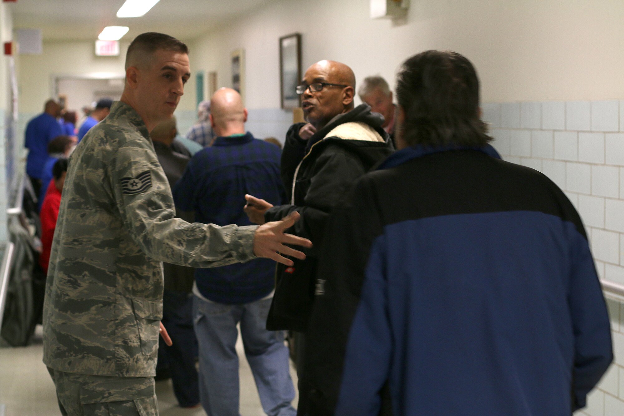 DAYTON, Ohio – Technical Sgt. Nicholas Nickert, 445th Aircraft Maintenance Squadron avionics technician, manages the line of veterans during the Dayton Veterans Affair’s Medical Center Homeless Stand down October 29, 2015.  More than 10 members of the 445th Airlift Wing volunteered for the event. This year’s homeless stand down provided  a meal, clothing, health screenings, VA and Social Security benefits counseling, and referrals to a variety of other necessary services, such as: housing, employment, substance abuse and mental health treatment services to more than 300 veterans. The purpose of the event is to raise awareness for the difficulty in which Veterans and their families endure.  (U.S. Air Force photo /Tech. Sgt. Patrick O’Reilly)