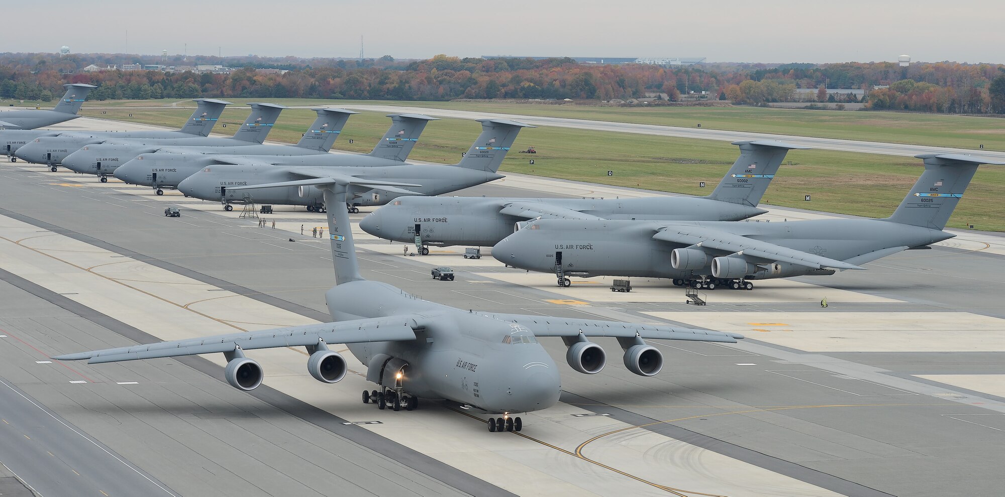 A C-5M Super Galaxy aircraft taxis with other C-5Ms in the background Nov. 2, 2015, at Dover Air Force Base, Del. Dover is home to the Air Forces’ only isochronal maintenance facility for C-5 aircraft, some of which were experiencing smoke in the cockpit after completing ISO maintenance. Experts from Team Dover’s 436th Maintenance Squadron created a low-cost piece of equipment that has fixed the problem and is in the process of being implemented Air Force-wide. (U.S. Air Force photo/Greg L. Davis)