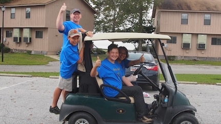 Chaplain Ryan Ayers, 628th Air Base Wing chaplain, and his spouse Thu-Tao with children Sean and Peyton, give thumbs up prior to beginning a scavenger hunt at the Short Stay Recreation Area in Moncks Corner, S.C. on Nov. 7, 2015. Ayers and his family participated in a family weekend retreat, which was centered on how families play, learn, grow and relax together. (Courtesy photo/Angela Cottman)