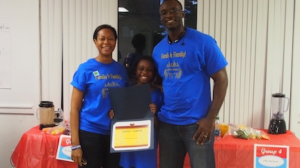 Maj. Kimberly Champagne (left) and her spouse Maj. Cyrus Champagne, both members of the 315th Airlift Wing, join their daughter Sara Grace for a photo after winning the “Chopped Family Competition” during a free family weekend retreat at the Short Stay Recreational Area in Moncks Corner, S.C. on Nov. 7, 2015. Six families participated and were challenged to create a healthy smoothie with at least four fruits and three vegetables in five minutes. They were judged on creativity, presentation, taste, level of difficulty and if all ingredients were used. (Courtesy photo/Angela Cottman)