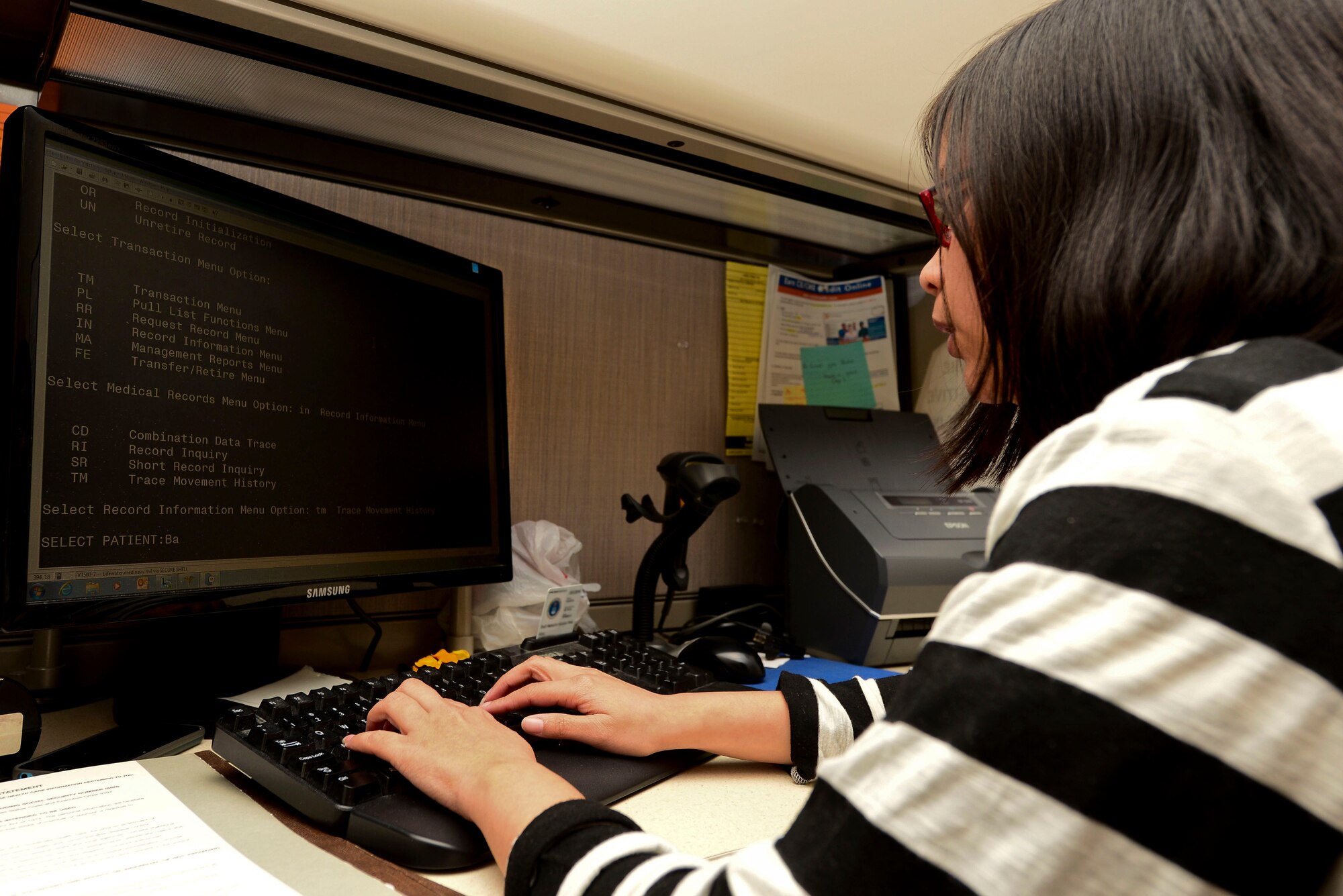 Christine Foo, a volunteer assigned to the 633rd Medical Group Flight Medical Clinic, checks patient records at Langley Air Force Base, Va., Nov. 9, 2015. Foo volunteers at the hospital five days a week providing administrative support for the medical staff. (U.S. Air Force photo by Airman 1st Class Derek Seifert)