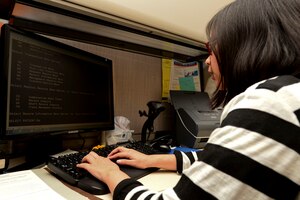 Christine Foo, a volunteer assigned to the 633rd Medical Group Flight Medical Clinic, checks patient records at Langley Air Force Base, Va., Nov. 9, 2015. Foo volunteers at the hospital five days a week providing administrative support for the medical staff. (U.S. Air Force photo by Airman 1st Class Derek Seifert)