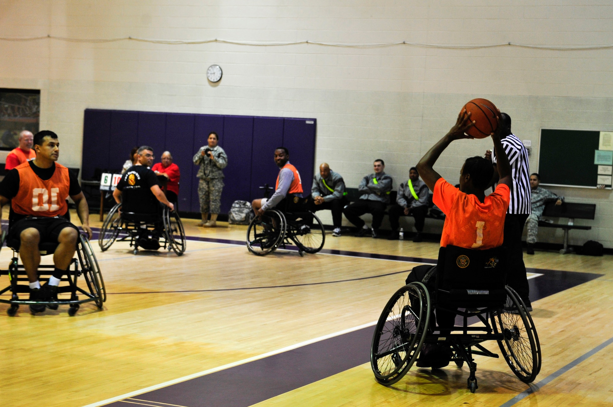 U.S. Army Capt. Catherine Pearson, the commander of the Alpha Company Warrior Transition Unit, passes a basketball during a wheelchair basketball game held during Warrior Care Month at McClellan Fitness Center at Fort Eustis, Va., Nov. 13, 2015.  Pearson said the goal of Warrior Care Month is to help Soldiers recognize what they can do versus what they can’t, due to injuries or illnesses. (U.S. Air Force photo by Senior Airman Breonna Veal)
