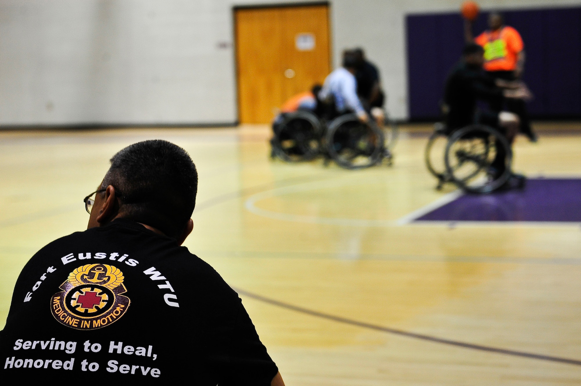 U.S. Army 1st Sgt. Roberto Gonzales, a first sergeant assigned to the Alpha Company Warrior Transition Unit, watches the wheelchair basketball game at McClellan Fitness Center at Fort Eustis, Va., Nov. 13, 2015. November is Warrior Care Month, a time where wounded, ill or injured Soldiers are recognized for their strength and resiliency.(U.S. Air Force photo by Senior Airman Breonna Veal)