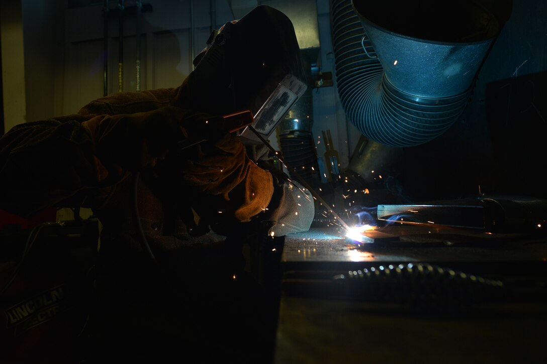U.S. Army Pvt. Hunter Ballew, a railway operation student with the Maritime and Intermodal Training school, welds during a class at Fort Eustis, Va., Oct. 23, 2015. As a part of railway operations, the students learn how to weld iron metals used in railway operations. (U.S. Air Force photo by Staff Sgt. Natasha Stannard)