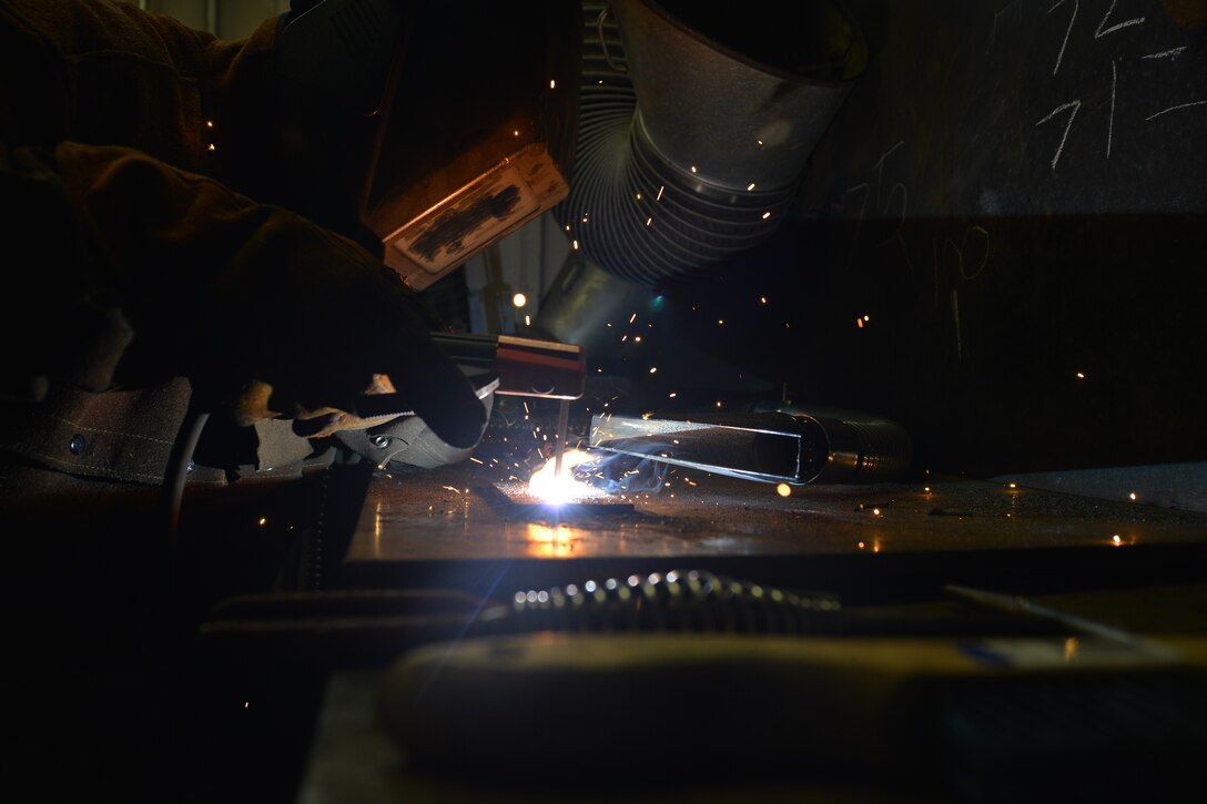 U.S. Army Pvt. Hunter Ballew, a railway operation student with the Maritime and Intermodal Training school, welds iron metals together during a class at Fort Eustis, Va., Oct. 23, 2015. The shop teaches various techniques that prepare students to weld small and large parts of rail and vessels. (U.S. Air Force photo by Staff Sgt. Natasha Stannard)