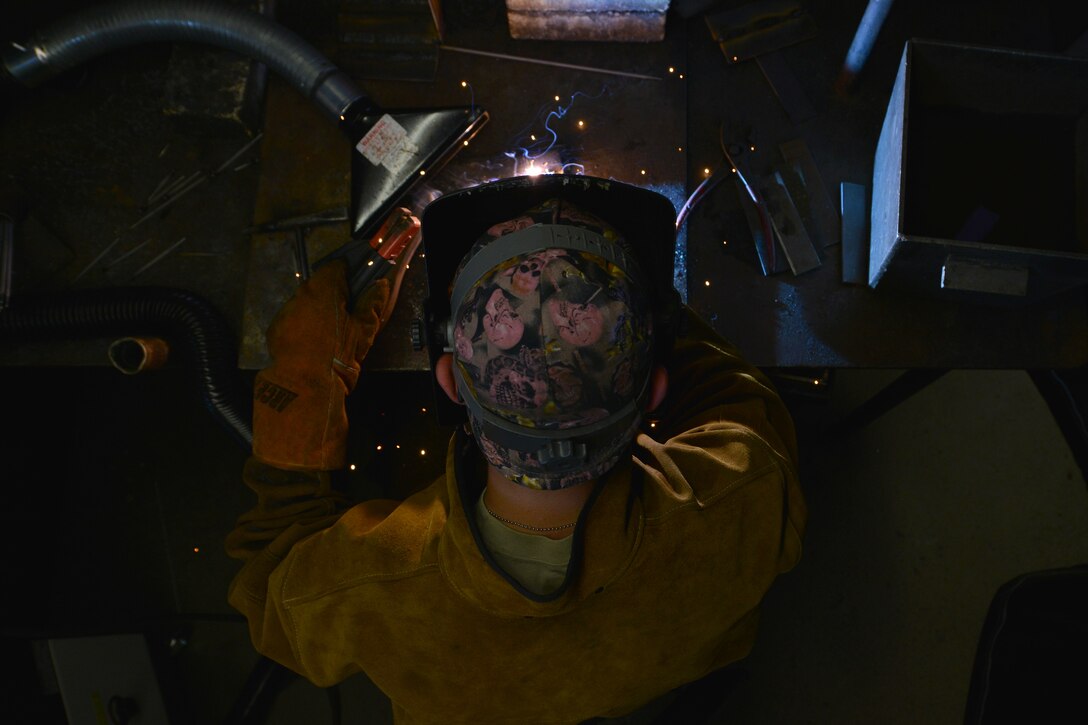 U.S. Army Pfc. Edward Allen, a railway operation student with the Maritime and Intermodal Training school, welds iron metals together during a class at Fort Eustis, Va., Oct. 23, 2015. The students go through three days of the course, which begins with classroom and simulator training. (U.S. Air Force photo by Staff Sgt. Natasha Stannard)