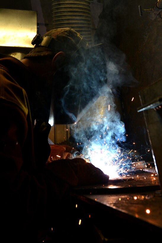 U.S. Army Pfc. Edward Allen, a railway operation student with the Maritime and Intermodal Training school, welds pieces of metal together during the welding portion of the railway course at Fort Eustis, Va., Oct. 23, 2015. The students learn the concept of welding through classroom, simulator and hands-on techniques in order to advise joint and coalition partners on the process. (U.S. Air Force photo by Staff Sgt. Natasha Stannard) 