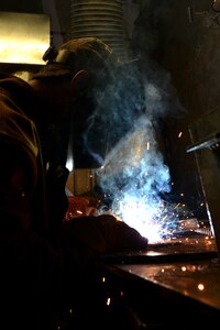 U.S. Army Pfc. Edward Allen, a railway operation student with the Maritime and Intermodal Training school, welds pieces of metal together during the welding portion of the railway course at Fort Eustis, Va., Oct. 23, 2015. The students learn the concept of welding through classroom, simulator and hands-on techniques in order to advise joint and coalition partners on the process. (U.S. Air Force photo by Staff Sgt. Natasha Stannard) 