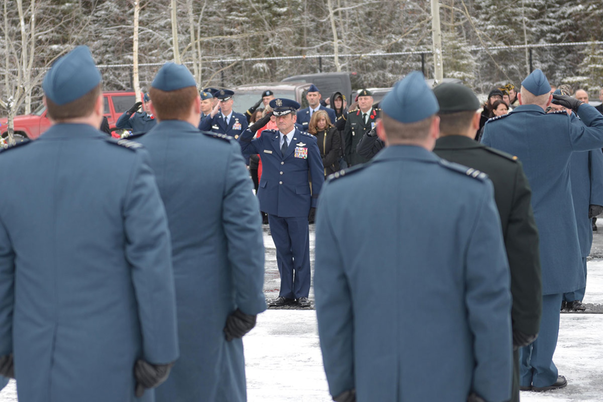 Air Force Lt. Gen. Russell J. Handy, commander, Alaskan Command, U.S. Northern Command; commander, Eleventh Air Force, Pacific Air Forces; and commander, Alaskan North American Aerospace Defense Region, North American Aerospace Defense Command, renders a salute to Royal Canadian Armed Forces service members during the Remembrance Day Ceremony at the Fort Richardson National Cemetery on Joint Base Elmendorf-Richardson, Nov. 11. Hundreds of veterans and their families attended the ceremonies, which included music, speeches and wreath laying. (U.S. Air Force photo/Staff Sgt. William Banton)