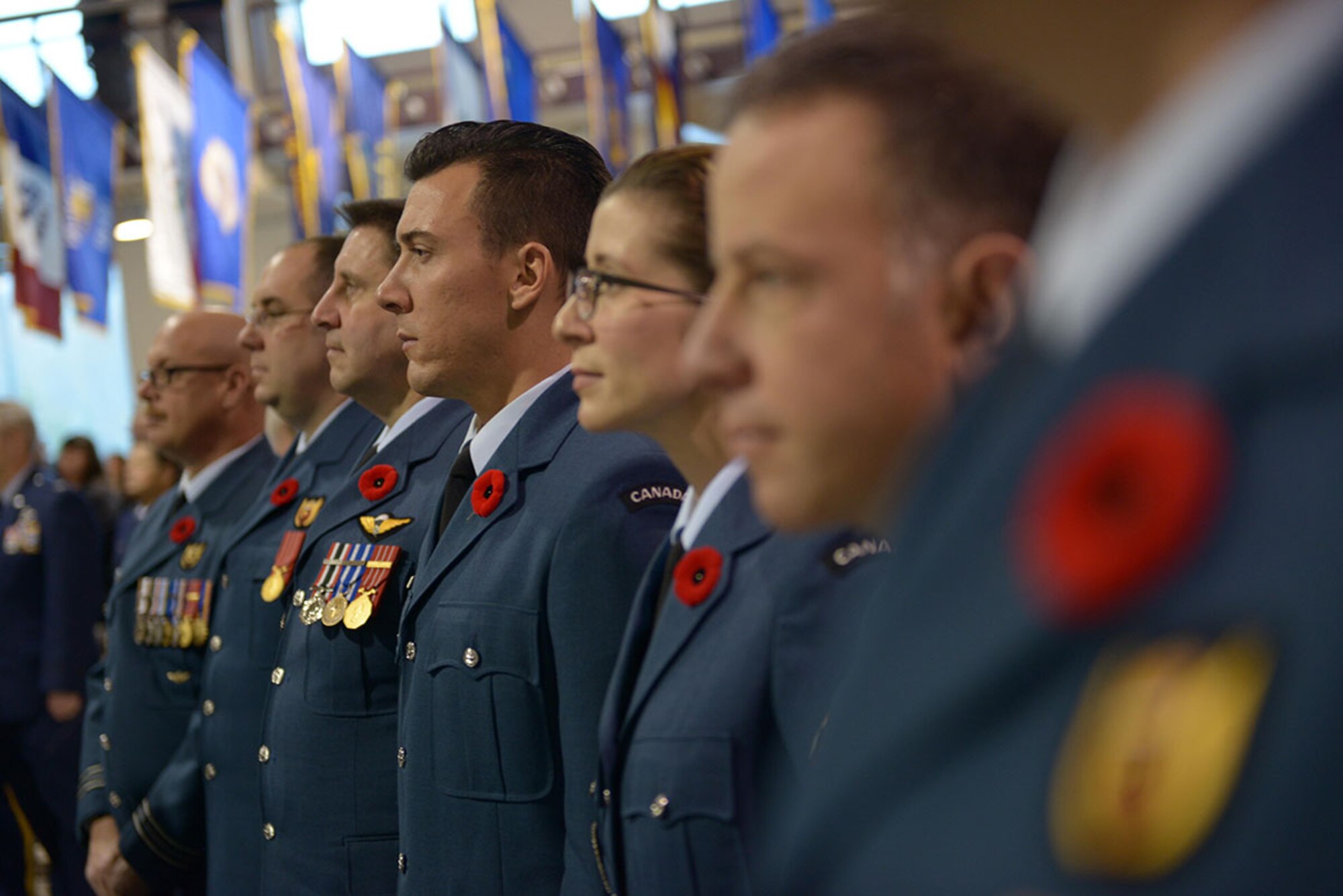 Royal Canadian Armed Forces service members stand at attention for the U.S. and Canada national athems, during the Alaska National Guard and Alasska Department of Military and Veterans Afairs Veterans Day ceremony, on Joint Base Elmendorf-Richards, Nov. 11. Hundreds of veterans and their families attended the ceremonies, which included music, speeches and wreath layings. (U.S. Air Force photos/Staff Sgt. William Banton)