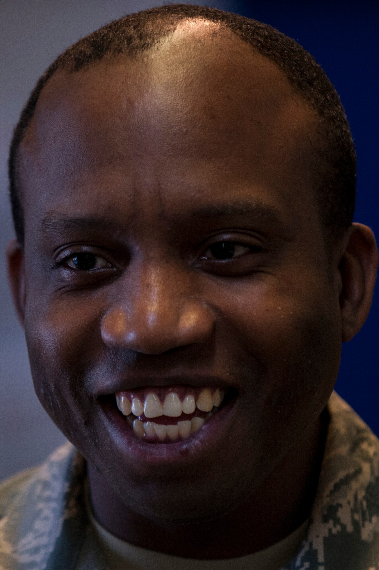 U.S. Air Force Staff Sgt. Paul Mims, 52nd Communications Squadron NCO in charge of registered mail, smiles inside the post office at Spangdahlem Air Base, Germany, Nov. 9, 2015. Postal clerks must process all mail within a 24-hour period excluding magazines which they must process in 72 hours. (U.S. Air Force photo by Senior Airman Rusty Frank/Released)