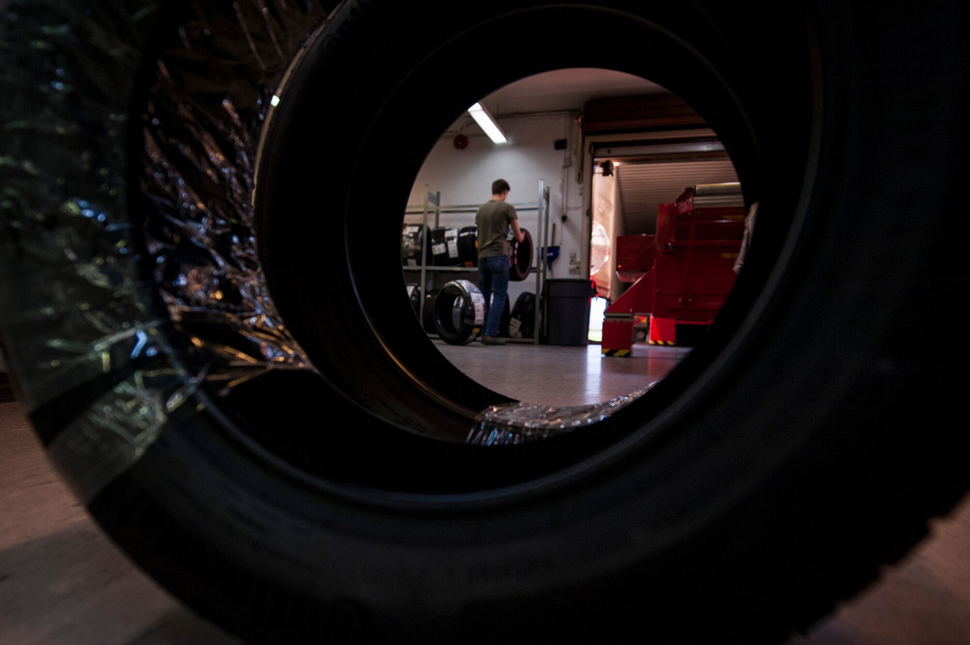 A postal clerk stocks a tire on a rack inside the post office at Spangdahlem Air Base, Germany, Nov. 4, 2015. The post office serves all base personnel. (U.S. Air Force photo by Senior Airman Rusty Frank/Released)