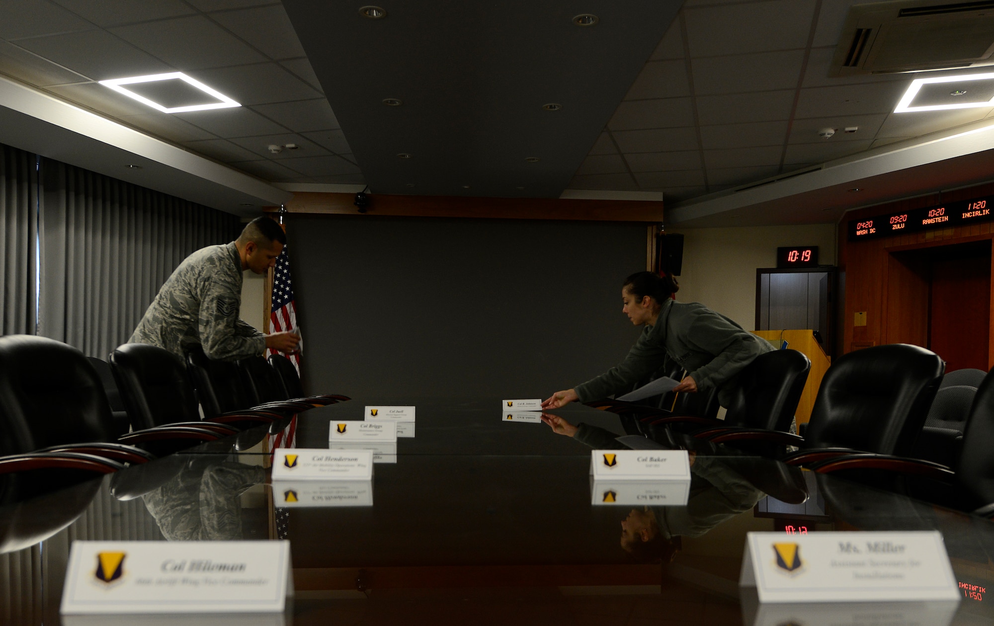 Tech. Sgt. Nicola Paille, right, 86th Airlift Wing Protocol NCO, and Tech. Sgt. Raul Rodriguez, 86th AW Protocol NCO in charge, arrange place settings for a meeting with a distinguished visitor Nov. 13, 2015, at Ramstein Air Base, Germany. The 86th AW Protocol office strives to make Ramstein look professional, efficient and ready to all who visit the base. (U.S. Air Force photo/Airman 1st Class Tryphena Mayhugh)