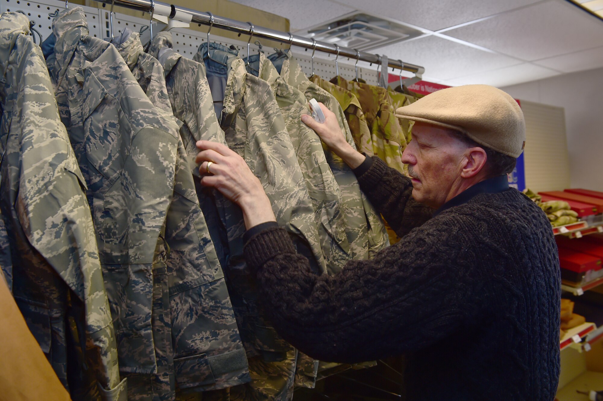 Robert A. Weinberg, Envision Express employee, looks through inventory Nov. 18, 2015, on Buckley Air Force Base, Colo. Weinberg worked as an accomplished photographer before losing part of his eyesight in the mid 1990’s. (U.S. Air Force photo by Airman 1st Class Luke W. Nowakowski/Released)