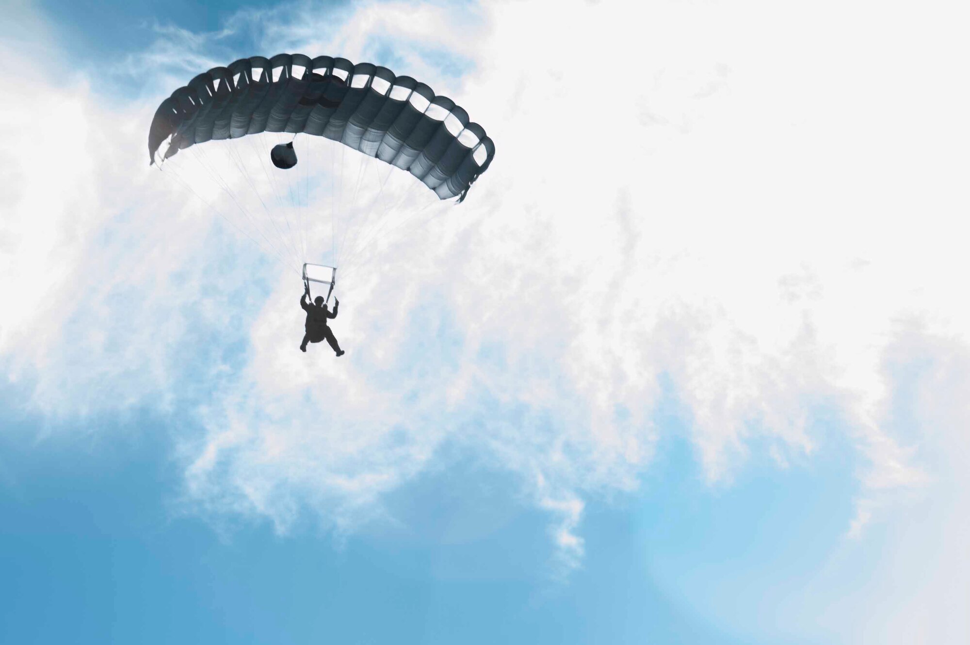 A 19th Operations Support Squadron survival, evasion, resistance and escape specialist free-falls from a UH-60 Blackhawk Nov. 12, 2015, at Camp Robinson, Ark. SERE specialists must maintain mission readiness by practicing military free-fall jumps while being subjected to multiple scenarios as part of their training. (U.S. Air Force photo by Airman 1st Class Mercedes Muro) 