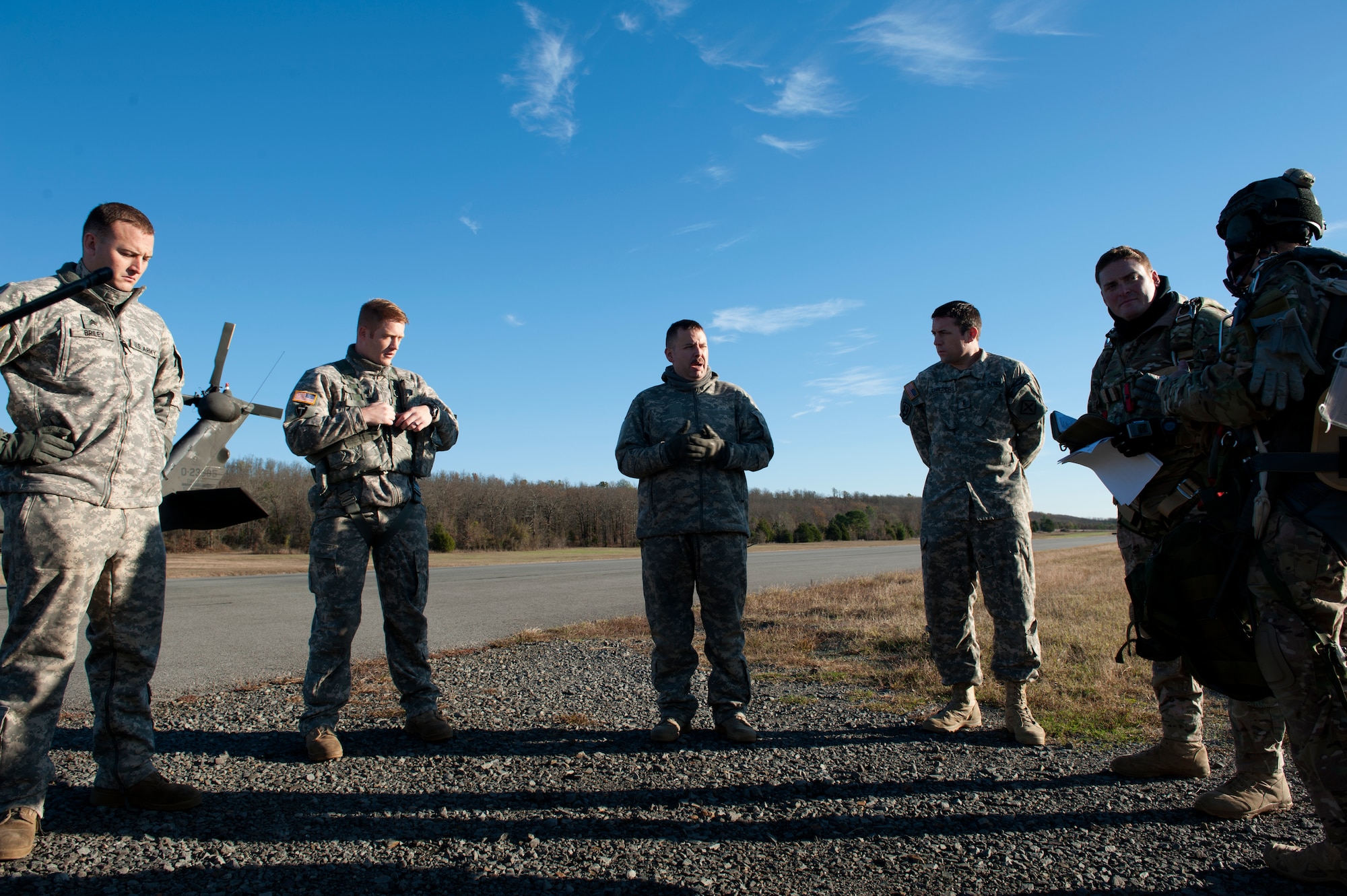 U.S. Army Staff Sgt. Jonathan Watson, 77th Theater Aviation Brigade standardization inspector and UH-60 Blackhawk pilot, briefs survival, evasion, resistance and escape specialists from the 19th, 375th and Air Mobility Command Headquarters before a flight Nov. 12, 2015, at Camp Robinson, Ark. The SERE specialists teamed up with the U.S. Army personnel assigned to the 77th Theater Aviation Brigade as well as combat control students assigned to the Special Tactics Training Squadron at Hurlburt Field, Fla., as part of required training. (U.S. Air Force photo by Airman 1st Class Mercedes Muro) 
