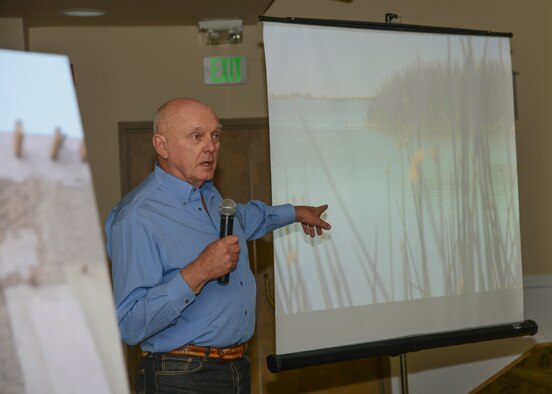 Dr. Bruce Love shows a photo of Piute Ponds, which he says is much like what the Antelope Valley used to look like before the dry lakebeds were formed. (U.S. Air Force photo by Rebecca Amber)