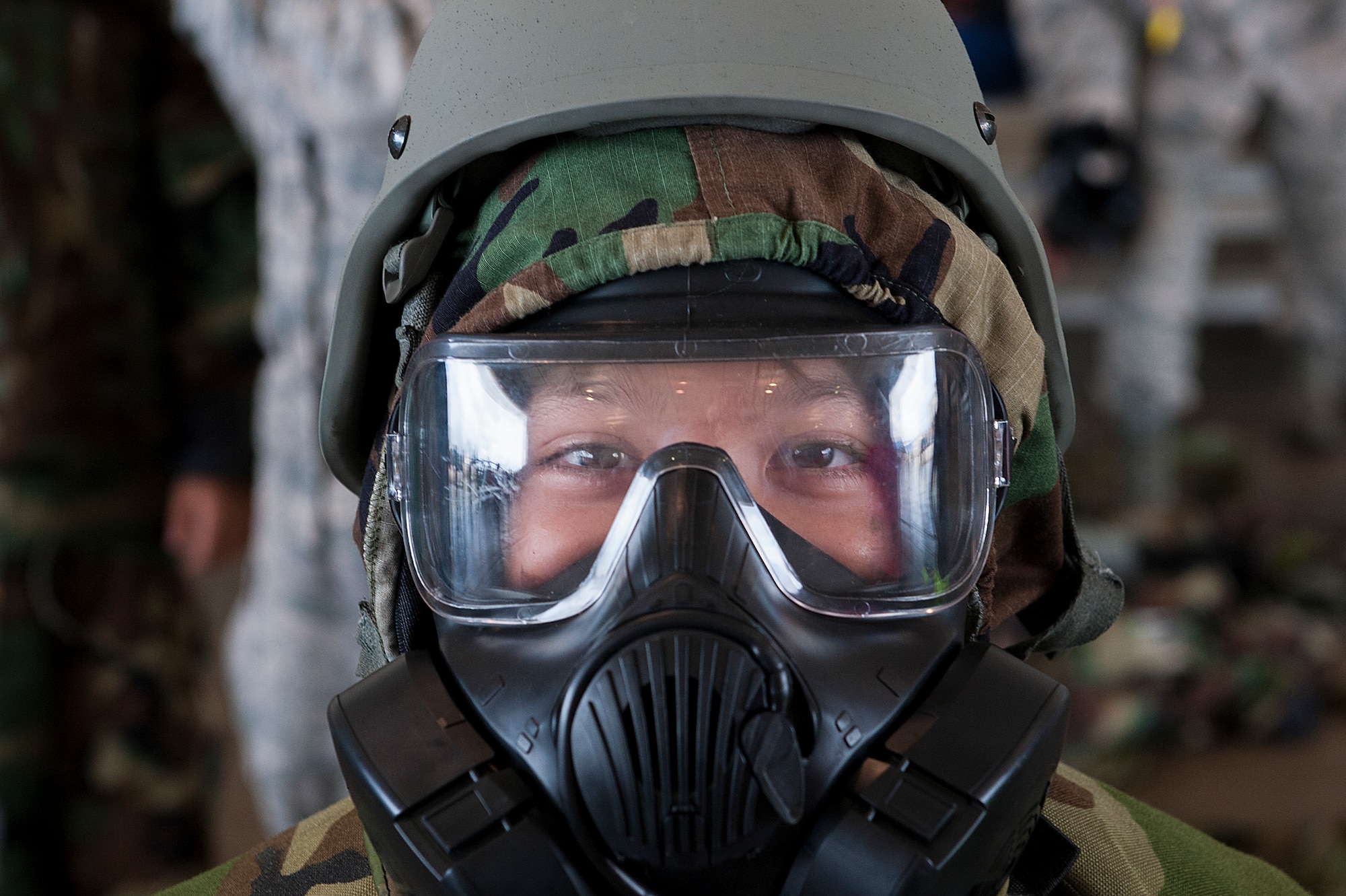 A child tries on a gas mask and mission oriented protective posture (MOPP) gear at Skoshi Warrior Nov. 14, 2015, at Kadena Air Base, Japan. Skoshi Warrior is an annual event designed to help children understand some of the deplyment processes that their military parents go through. (U.S. Air Force photo by Airman 1st Class Corey M. Pettis)