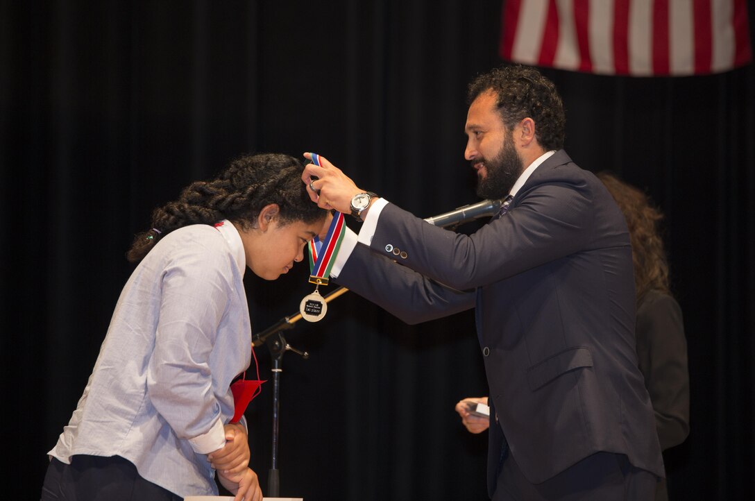 Makaiya Harris, first place winner of the advanced group, receives a gold medal at the 54th Annual Japanese and English Speech Contest at the Sinfonia Iwakuni in Iwakuni, Japan, Nov. 8, 2015. Japanese contestants wrote their own speeches in English and American students delivered theirs in Japanese. The ultimate goal of the speech contest is to promote understanding and friendship between Americans and Japanese.