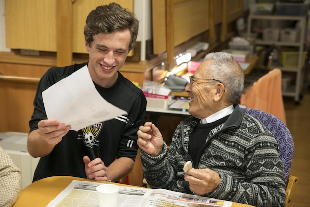Aidan Lewis, a National Honor Society student at Marine Corps Air Station Iwakuni, Japan, helps Muranaka Masumi, a resident at the Kaede Nursing Home, paint a Christmas tree ornament during the students’ visit to the home, Nov. 17, 2015. Giving back to the community during events like this helps strengthen the bond between the station and the local community. (U.S. Marine Corps photo by Cpl. Carlos Cruz/Released)