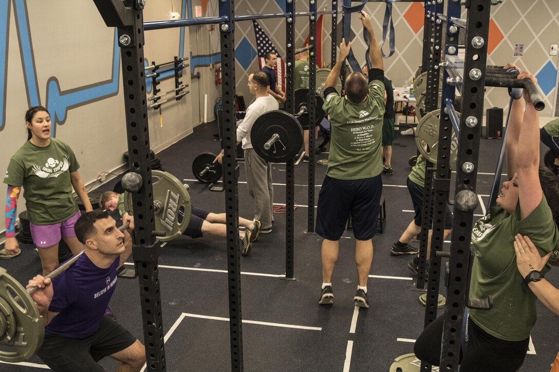 Participants conduct their various circuit repetitions during the MacDonald Hero Workout event at Iron Empire gym in Dover, New Hampshire, Nov. 10, 2015. Iron Empire hosted a community workout in honor Lance Cpl. MacDonald, a Marine who lost his life in Iraq in 2003, or whomever the participants individually wanted to honor.