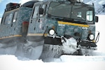 An M973A1 Small Unit Support Vehicle, also known as an SUSV, sporting emergency lights and digital camouflage, claws its way through the snow at Taylor Park Reservoir near Gunnison, Colorado, March 15, 2010. The SUSV, which is capable of traversing almost any terrain, is the primary vehicle used by the Colorado Army National Guard’s Snow Response Team. 