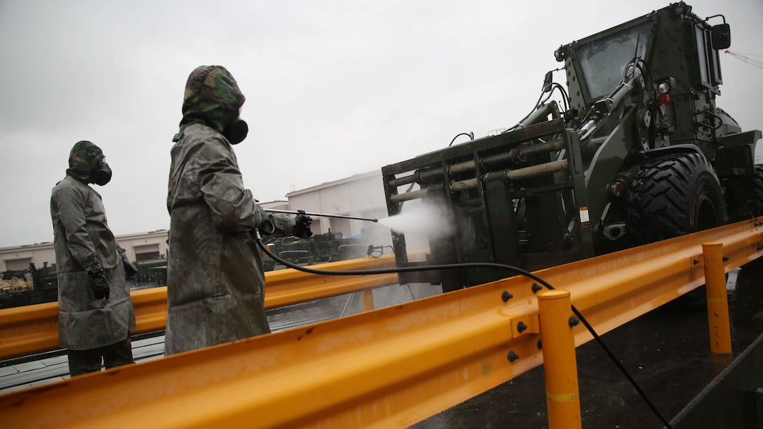 Reconnaissance, surveillance and decontamination Marines decontaminate a John Deere TRAM 624KR tractor during a simulated chemical attack at the Marine Wing Support Squadron 171 motor transportation wash rack at Marine Corps Air Station Iwakuni, Japan, Nov. 18, 2015. As part of an operational decontamination exercise, this mock attack refreshes RSD personnel’s skills in a chemical, biological, radiological and nuclear environment while preparing them for potential real world situations.