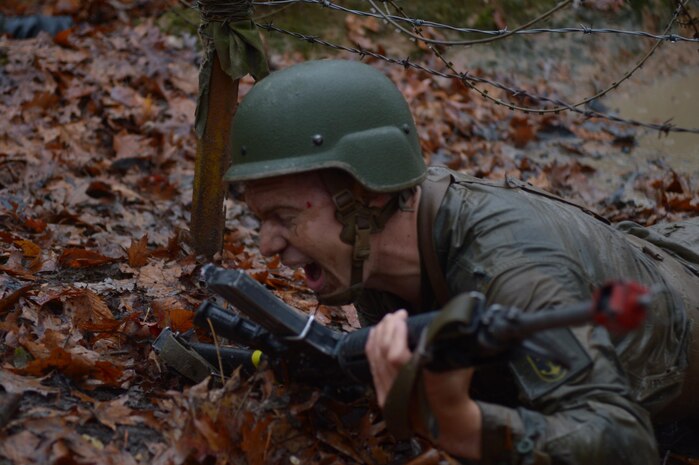 A Norwegian cadet pulls security while waiting for his team mates to navigate an obstacle on the Combat Course at Officer Candidate School.