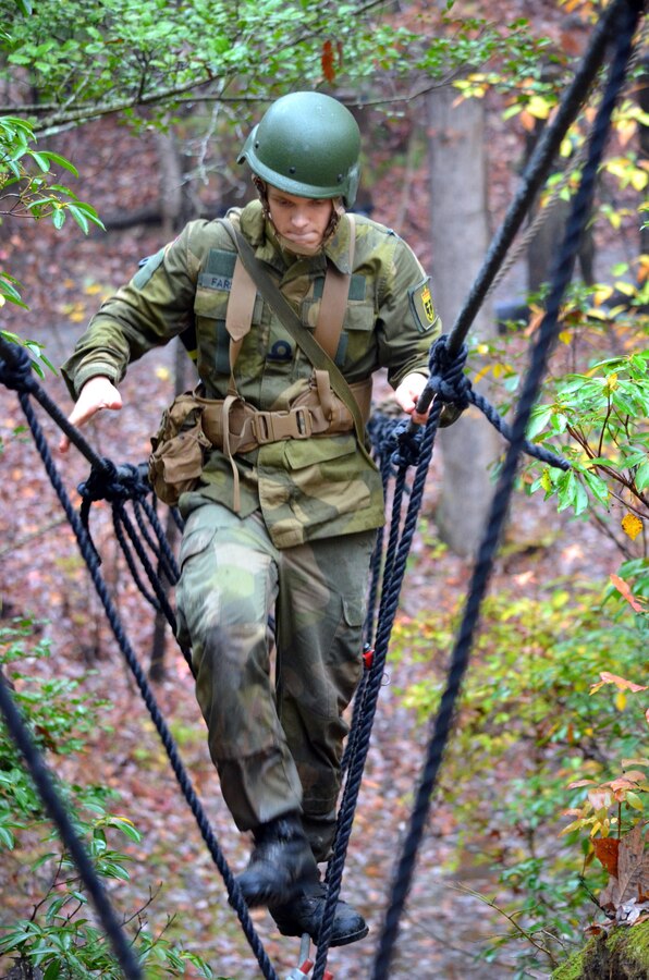 MARINE CORPS BASE QUANTICO, Va. — Cadet Tor Farstad, of the Royal Norwegian Naval Academy, crosses the rope bridge during the Combat Course at Officer Candidates School on Nov. 10, 2015.