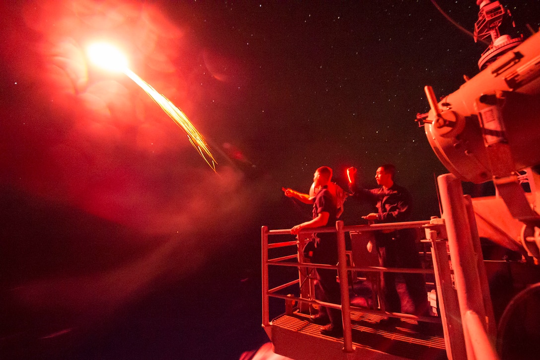 U.S. sailors aboard the USS Chancellorsville fire a pencil flare in waters south of Japan, Nov. 17, 2015. The Chancellorsville was participating in an annual exercise to increase interoperability between Japanese and American forces through training in air and sea operations. U.S. Navy photo by Petty Officer 2nd Class Raymond D. Diaz III