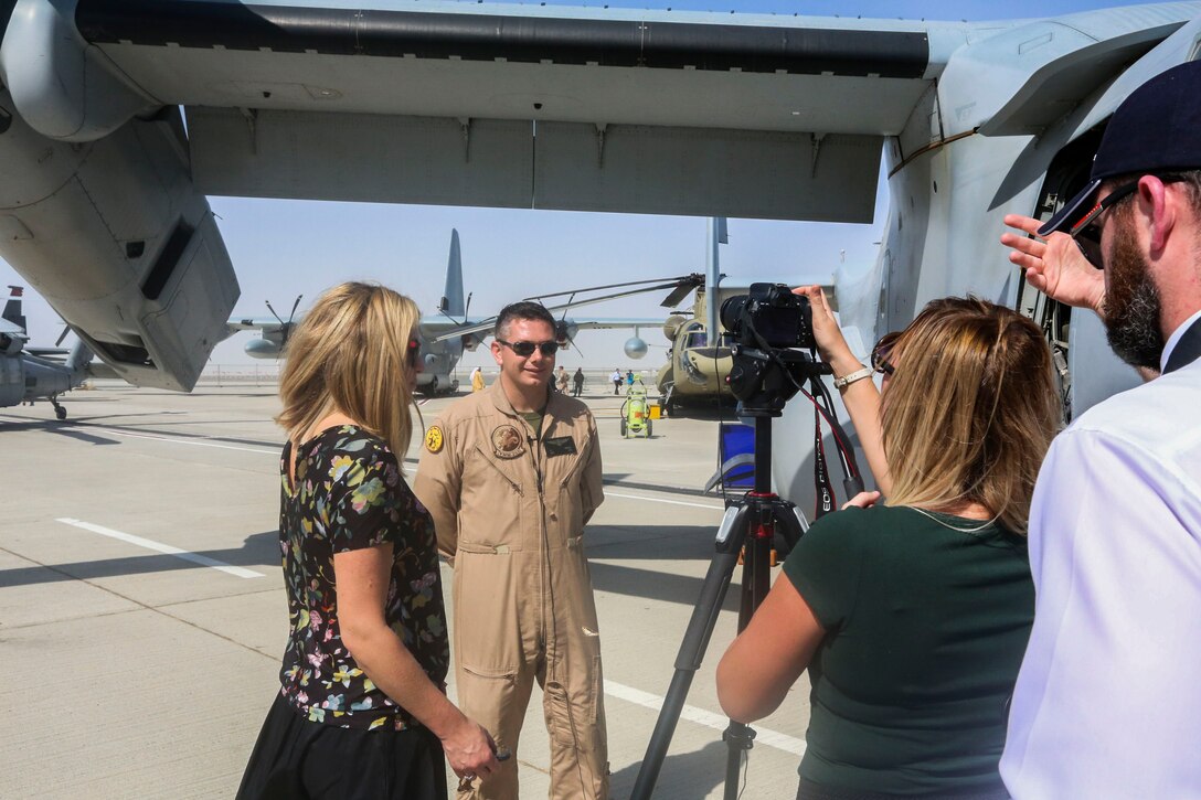 Capt. John Campbell, a pilot and a weapons and tactics instructor with the Red Dragons of Marine Medium Tiltrotor Squadron 268, Aviation Combat Element of Special Purpose Marine Air-Ground Task Force Crisis Response Central Command 16.1., conducts a media interview during 2015 Dubai Air Show, Dubai World Central, United Arab Emirates from November 8 - 12.