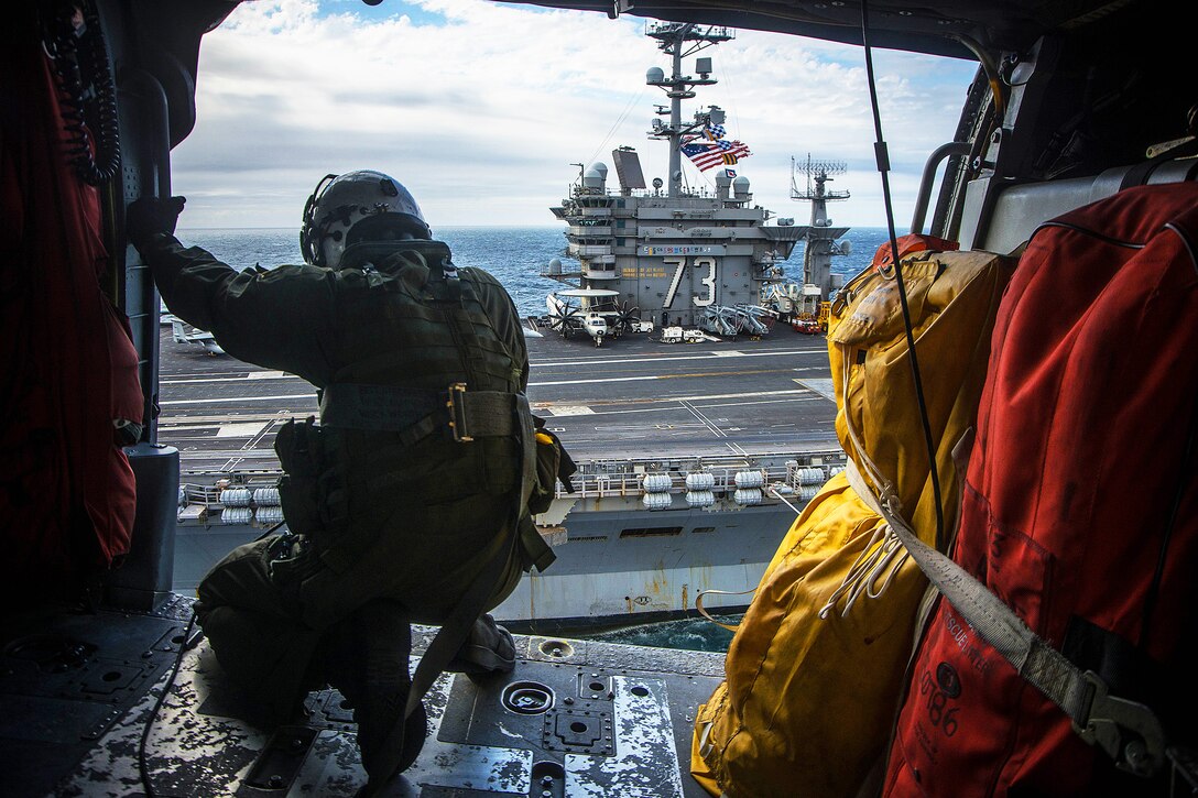 An MH-60S Seahawk helicopter prepares to land on the flight deck of the USS George Washington in the Atlantic Ocean, Nov. 17, 2015. The George Washington was participating in UNITAS, the U.S. Navy's longest-running annual multinational maritime exercise. U.S. Navy photo by Petty Officer 3rd Class Paul Archer