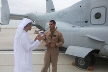 1st. Lt. Manuel Torres, a pilot with with the Red Dragons of Marine Medium Tiltrotor Squadron 268, Aviation Combat Element, Special Purpose Marine Air-Ground Task Force Crisis Response Central Command 16.1  reviews some of the unit's aviation capabilities to one of the thousands of visitors at the 2015 Dubai Air Show, Dubai World Central, United Arab Emirates from November 8 - 12.