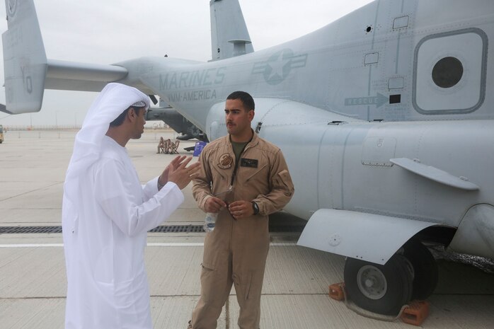 1st. Lt. Manuel Torres, a pilot with with the Red Dragons of Marine Medium Tiltrotor Squadron 268, Aviation Combat Element, Special Purpose Marine Air-Ground Task Force Crisis Response Central Command 16.1  reviews some of the unit's aviation capabilities to one of the thousands of visitors at the 2015 Dubai Air Show, Dubai World Central, United Arab Emirates from November 8 - 12.
