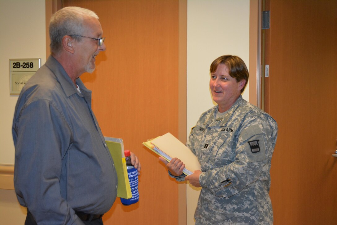 Michael Jackson, who prefers to be called Wolf, says goodbye to Capt. Tanya Mayes, a military justice and admin law attorney, assigned to the 80th Training Command Office of the Staff Judge Advocate, after Mayes provided the Vietnam veteran with legal assistance at Hunter Holmes McGuire VA Medical Center, Richmond, Va. Staff members of the 80th TC OSJA volunteer their services once a month at the medical center helping Wounded Warriors and veterans who qualify for legal benefits. Mayes lead an effort to establish the clinic after her husband, Raymond Pacheco, a nurse at the medical center, told her that a significant number of his patients needed legal assistance.