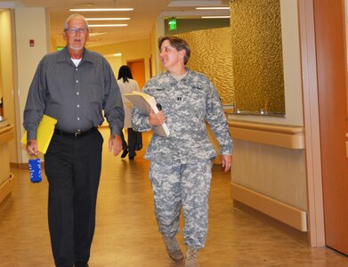 Capt. Tanya Mayes, a military justice and admin law attorney, assigned to the 80th Training Command Office of the Staff Judge Advocate, escorts Michael Jackson, who prefers to be called Wolf, to a legal clinic at Hunter Holmes McGuire VA Medical Center, Richmond, Va. Staff members of the 80th TC OSJA volunteer their services once a month at the medical center helping Wounded Warriors and veterans who qualify for legal benefits. Mayes lead an effort to establish the clinic after her husband, Raymond Pacheco, a nurse at the medical center, told her that a significant number of his patients needed legal assistance.