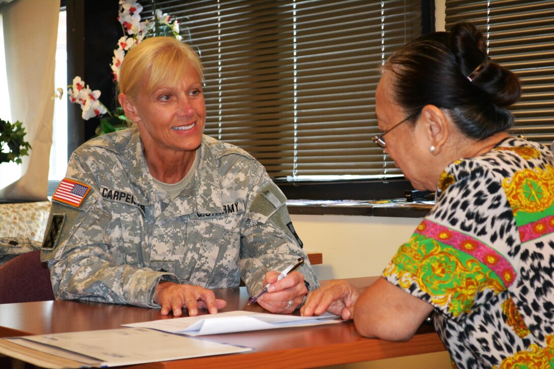 Lt. Col. Phyllis Carpenter, deputy 80th Training Command Staff Judge Advocate, provides legal advice the spouse of a veteran at Hunter Holmes McGuire VA Medical Center, Richmond, Va. Staff members of the 80th TC Office of the SJA volunteer their services once a month at the medical center helping Wounded Warriors and veterans who qualify for legal benefits. 