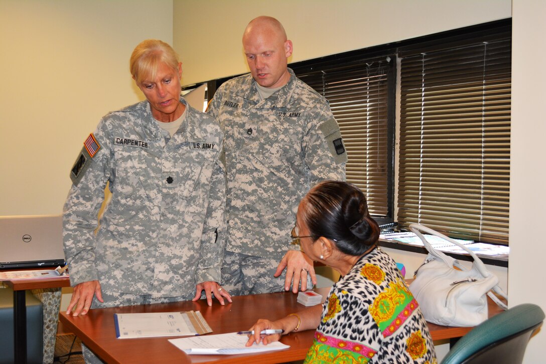 Lt. Col. Phyllis Carpenter, deputy 80th Training Command Staff Judge Advocate, and Sgt. 1st Class Sven Butler, paralegal 80th TC, provide legal advice the spouse of a veteran at Hunter Holmes McGuire VA Medical Center, Richmond, Va. Staff members of the 80th TC Office of the SJA volunteer their services once a month at the medical center helping Wounded Warriors and veterans who qualify for legal benefits. 