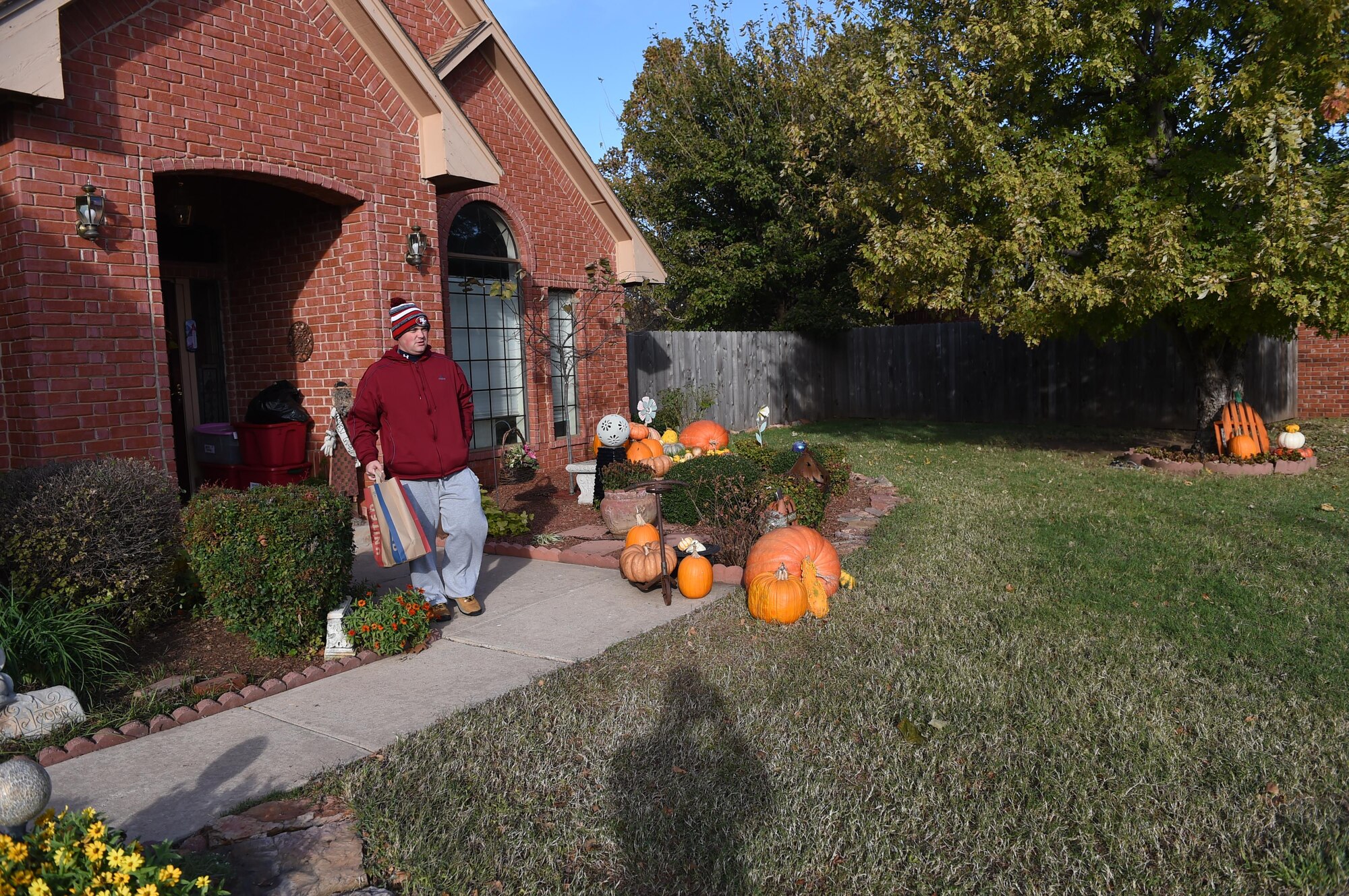 U.S. Air Force Tech. Sgt. Herbert Williams, 97th Force Support Squadron NCO in charge of the Altus Air Force Base Honor Guard, picks up a food donation bag from the porch of a home Nov. 13, 2015 in Altus. The donated food is collected in support of the 29th annual Harvest for the Hungry campaign which donates food to families in need during the holidays. (U.S. Air Force photo by Senior Airman Dillon Davis/Released)