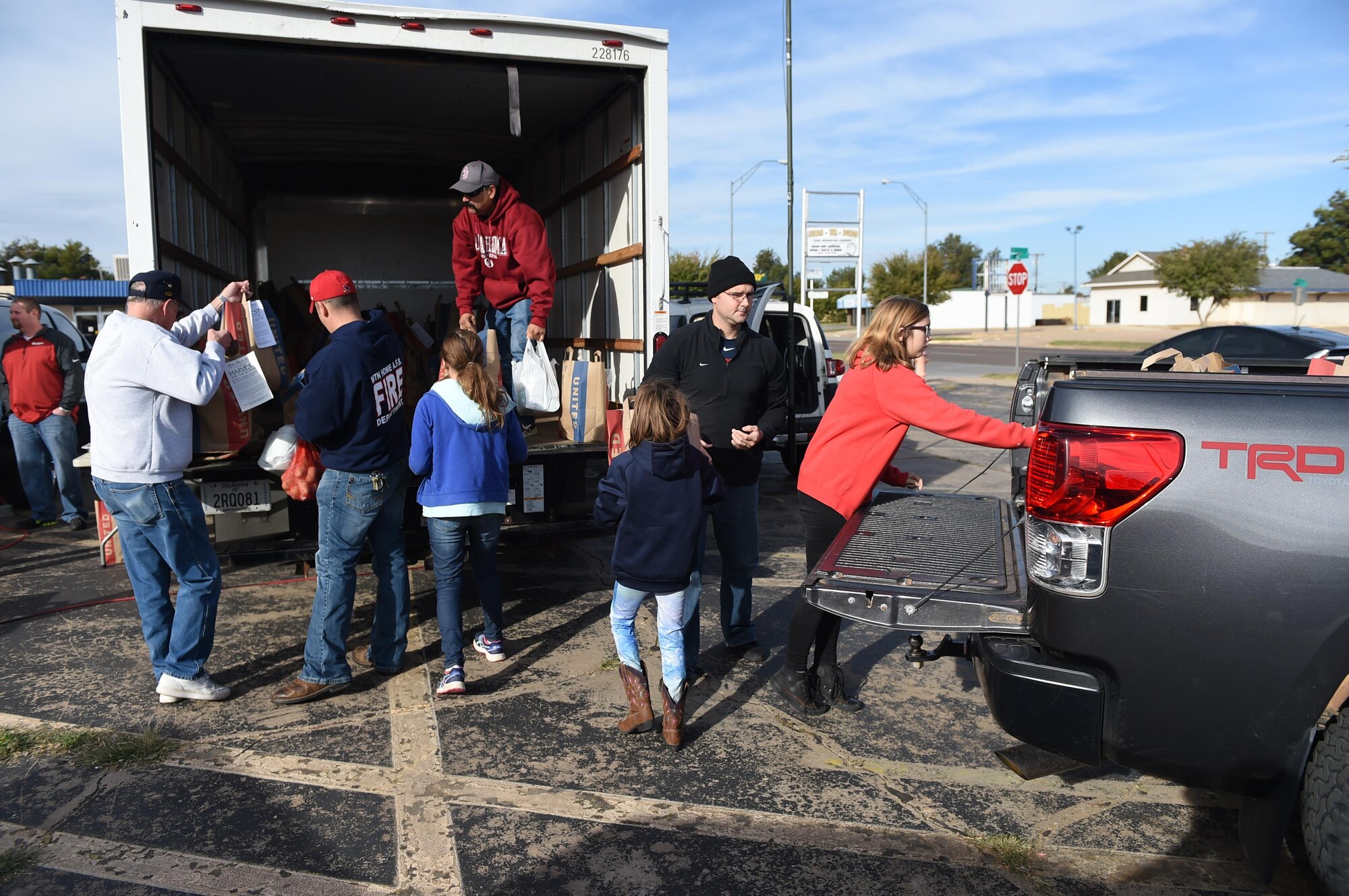 Members of Altus Air Force Base along with residents of the City of Altus load food donations onto a truck Nov. 13, 2015 in Altus. The donated food is collected in support of the 29th annual Harvest for the Hungry campaign which donates food to families in need during the holidays. (U.S. Air Force photo by Senior Airman Dillon Davis/Released)